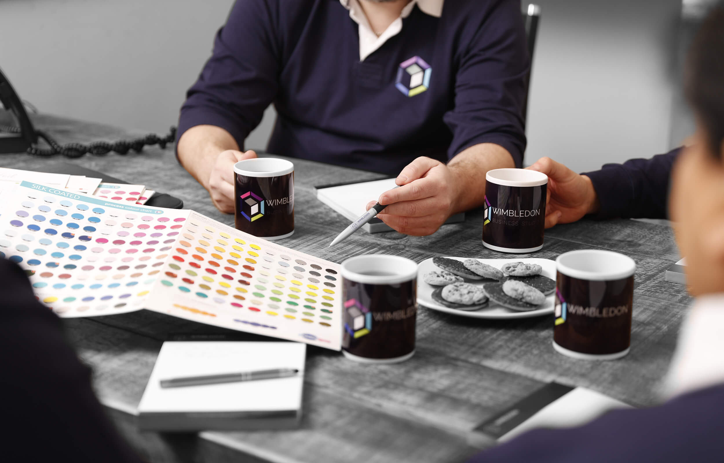 A group of people, having a meeting while drinking coffee